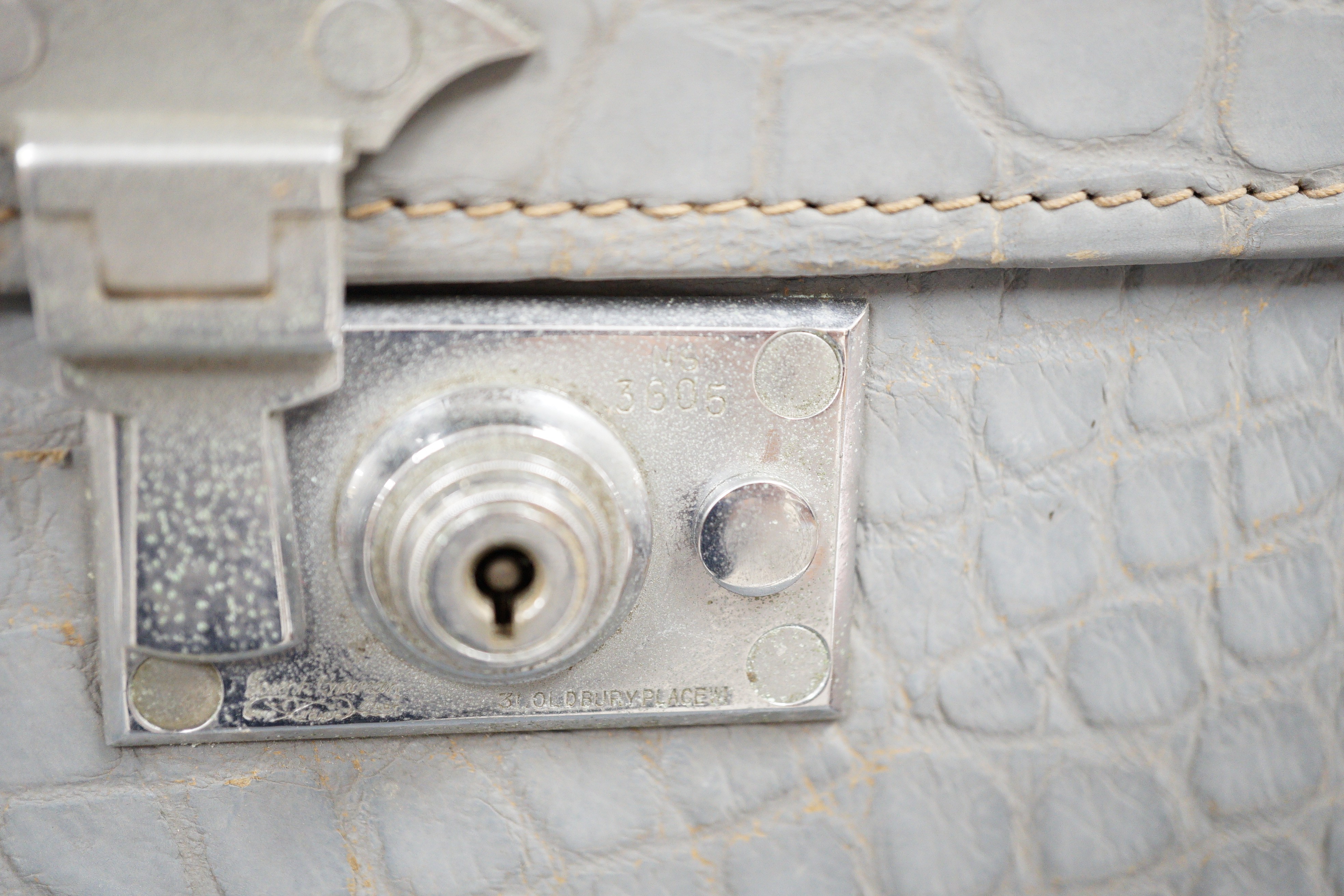 A pair of blue/grey faux crocodile suitcases
